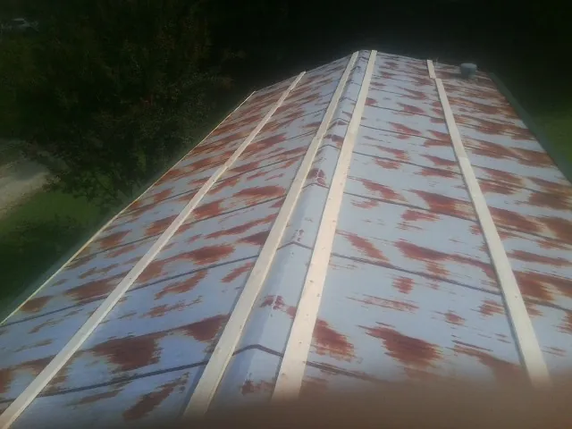 Rusted metal roof panels with new wood purlins before replacement — Storm Damage Roof Repair in Dolton by Roofing Brothers